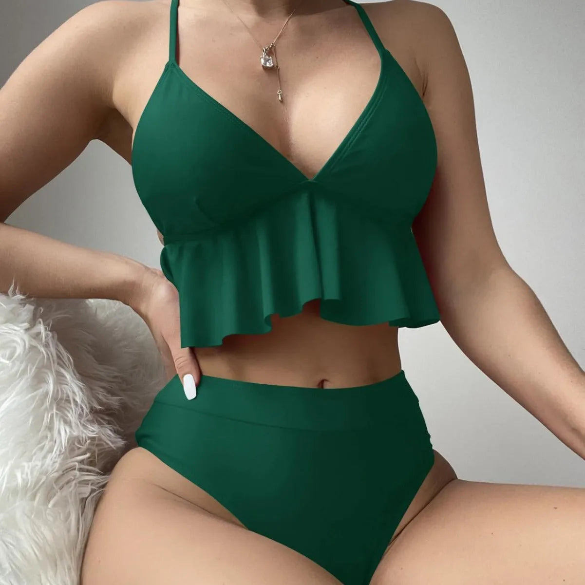 Women's solid colour split bikini swimsuit in polyester fabric on a mannequin
