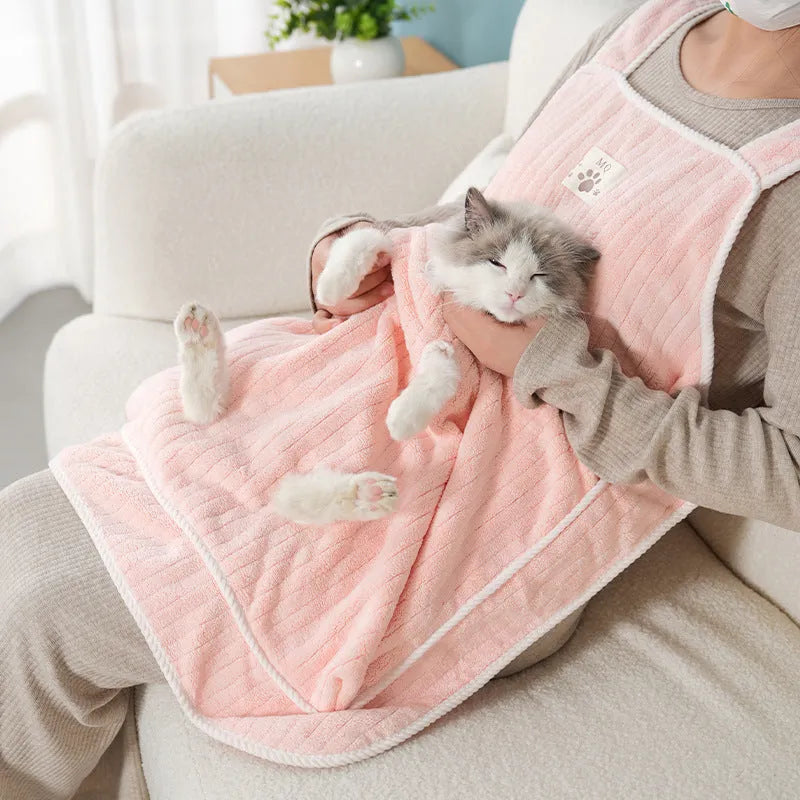 Cloth cat grooming apron worn by person holding a cat, shown in light blue colour with hole option.
