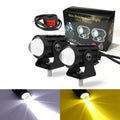 Motorcycle spotlight with dual-colour lens, aluminium housing, showing white and yellow light modes.