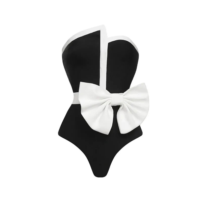 Women's black and white colour-block one-piece swimsuit with asymmetric bow detail