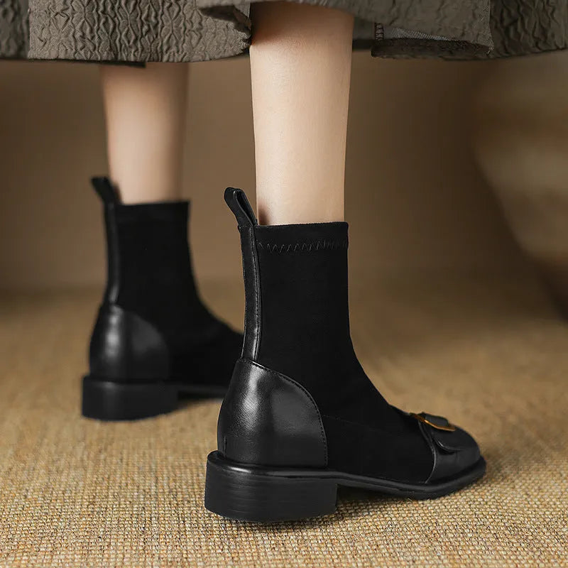 Women's black low heel Martin boot with lace-up front and decorative buckle stitching on a round toe.