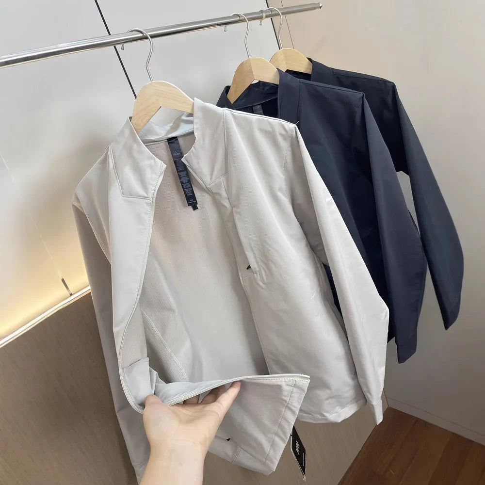 Man wearing a beige stand collar polyester casual jacket with long sleeves and a straight hem.