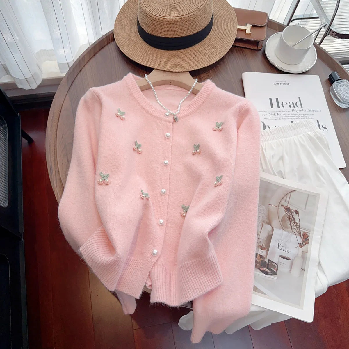 Women's pink cashmere blend cardigan coat with beaded detailing on the round neck, shown open as a slim-fit layer.