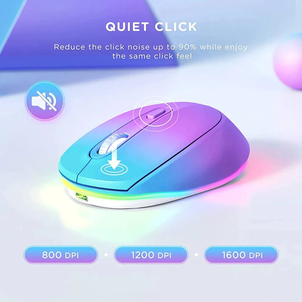 Compact white wireless mouse with ergonomic shape on a desk next to a laptop