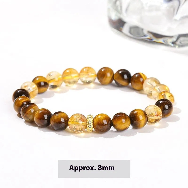 Women's geometric bracelet with natural yellow tiger stone and yellow tower crystal beads on wrist.