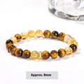 Women's geometric bracelet with natural yellow tiger stone and yellow tower crystal beads on wrist.
