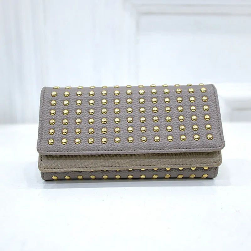 Women's long tri-fold wallet in black PU leather with silver rivet accents on front