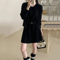 Women's black knitted vest skirt and long-sleeved cardigan two-piece set with pleats and a belt.