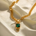 Gold electroplated geometric round pendant necklace with emerald zircon accents on Cuban link chain