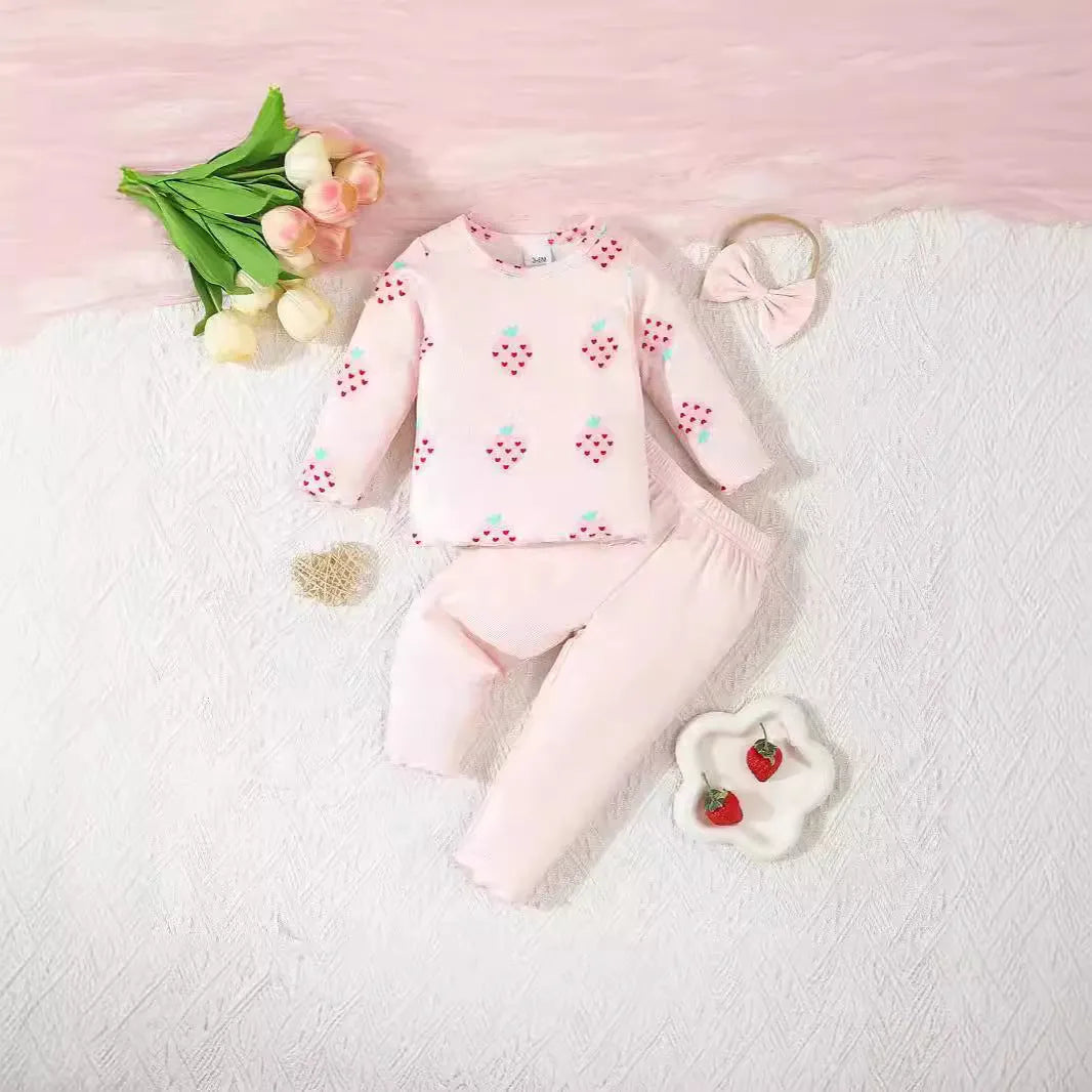 Infant wearing a printed long-sleeve top, solid trousers, and matching cap from the 3-piece suit set.