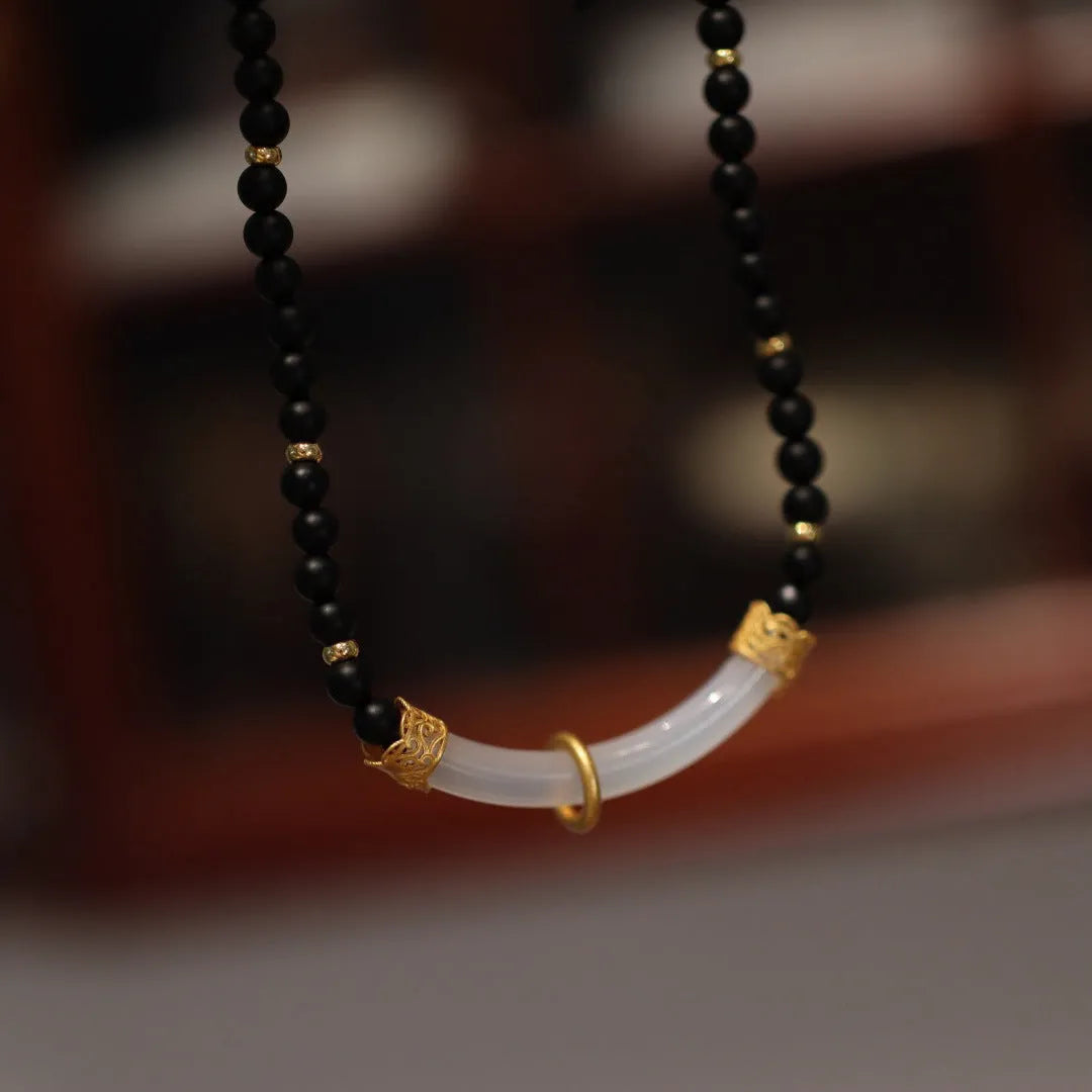 Natural frosted black agate and white chalcedony necklace with silver pendant on ball bead chain.