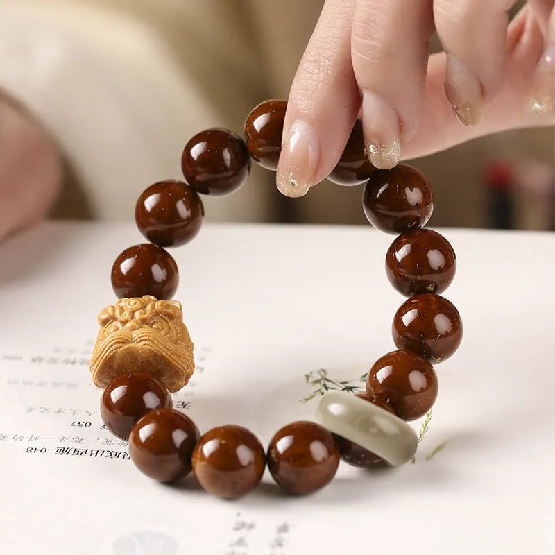 Hand-woven beaded circle bracelet with 13mm round beads in ivory nut, sandalwood, or yellow gradient bodhi style.