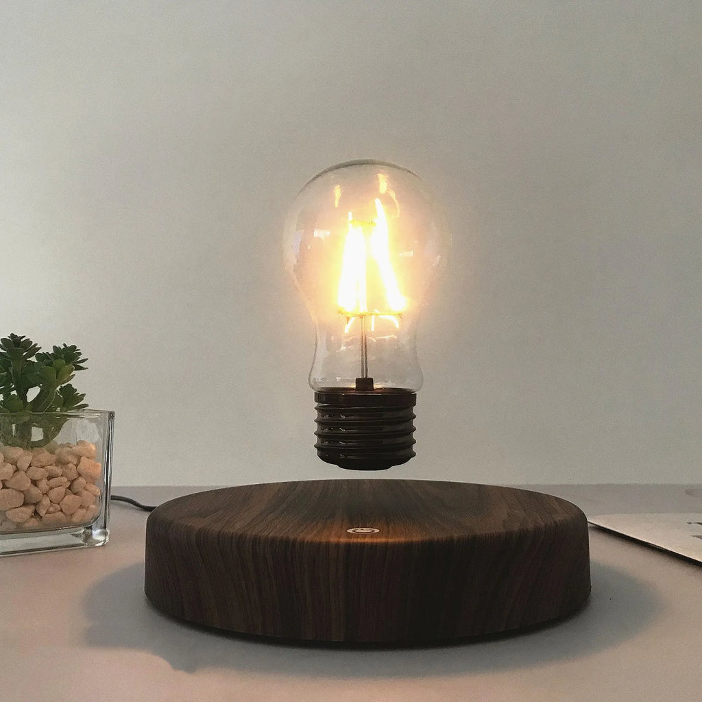 Magnetic levitation bulb night light in solid wood colour floating above desktop base