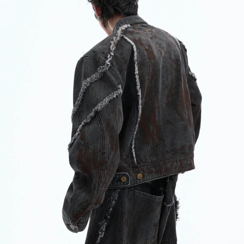 Black loose-fit denim jacket and trouser set with a splash-dye gradient pattern and padded shoulders.