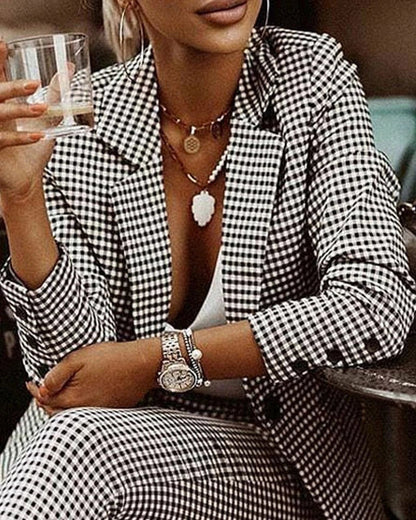 A stylish women's plaid suit set with a tailored blazer and slim-fit pants in black and white or blue colors.