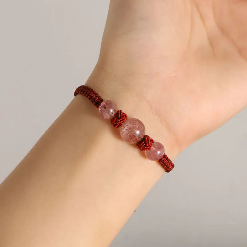Woven red rope bracelet with strawberry quartz beads and alloy clasp