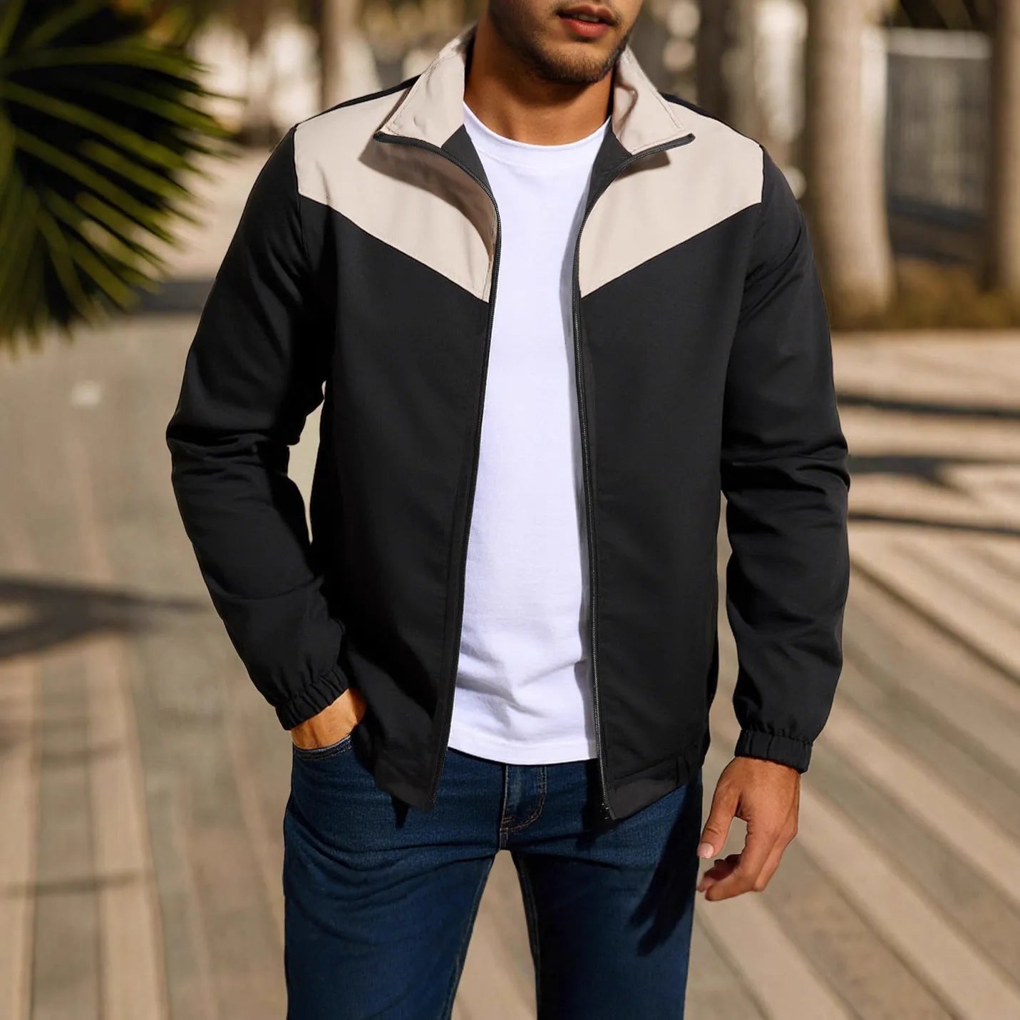 Men's green windproof jacket with a high collar and colour-matched zip, featuring raglan sleeves.