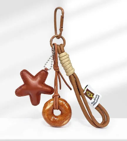 Handmade soda bread handbag pendant with baking varnish finish and brown star on brown strap.