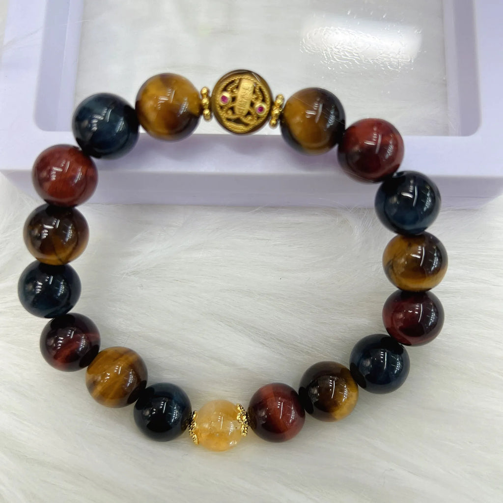 Natural golden-brown tiger eye gemstone bead bracelet with an adjustable clasp on a wrist.