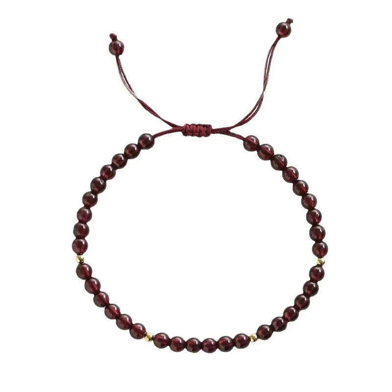 Hand-woven garnet bracelet with red rope and flexible wire construction showing national tide style