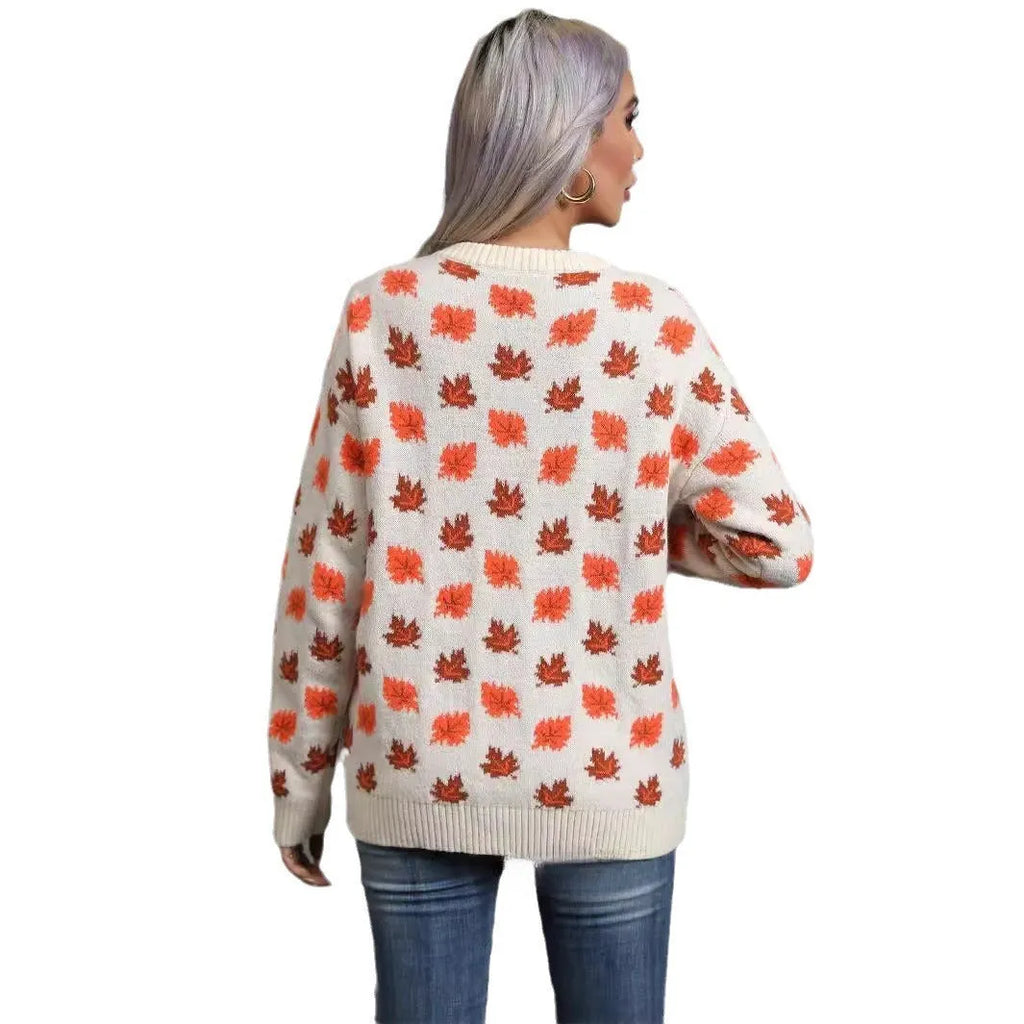 Loose fit beige Christmas sweater with a large dark maple leaf print on the front.