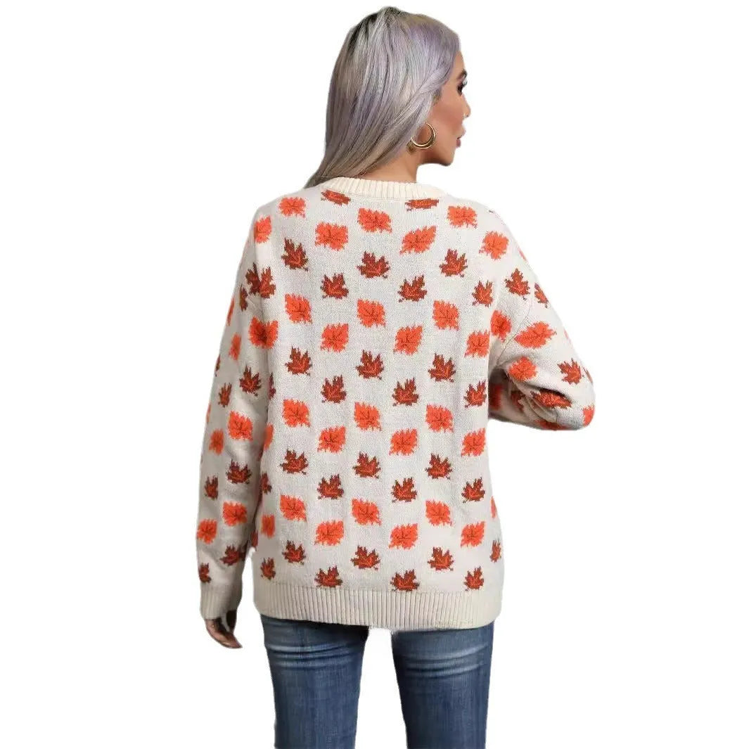 Loose fit beige Christmas sweater with a large dark maple leaf print on the front.