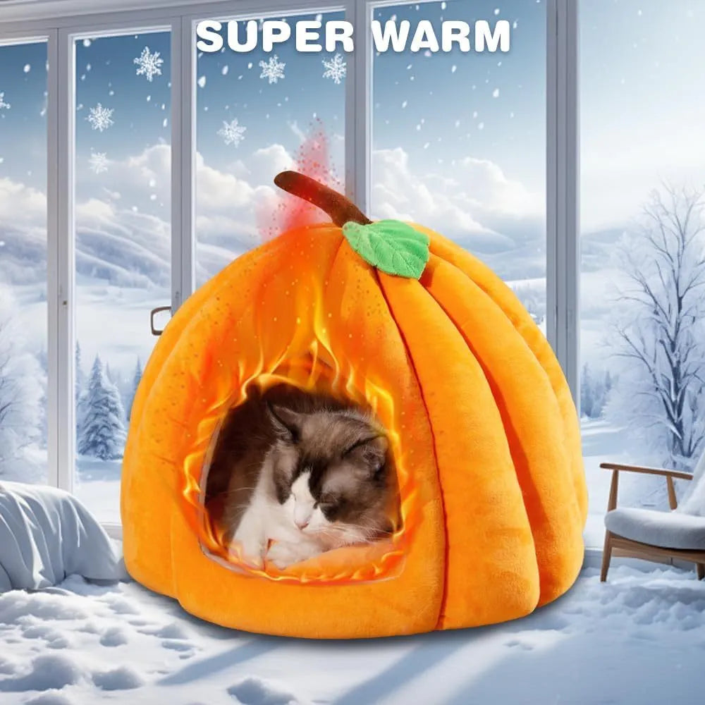 Pumpkin-shaped plush cat cave bed with a round entry hole on a wooden floor.