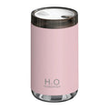 White USB humidifier emitting jellyfish-shaped smoke ring mist with warm night light glow on a table