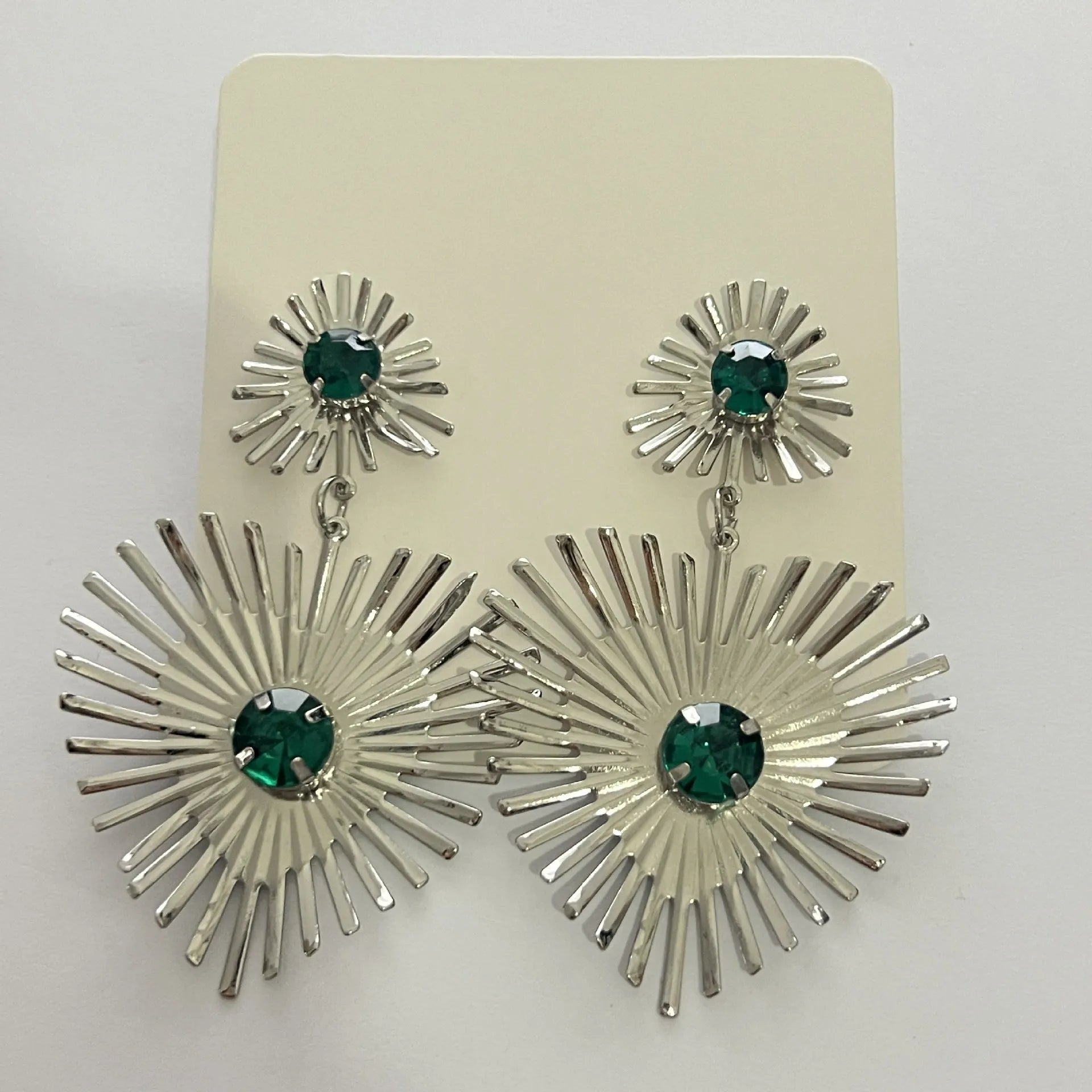 Bohemian sunflower heart-shaped earrings with rhinestones in gold finish on a white background