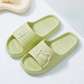Unisex cartoon bear EVA slippers in light green with open toe and flower detail for bathroom use