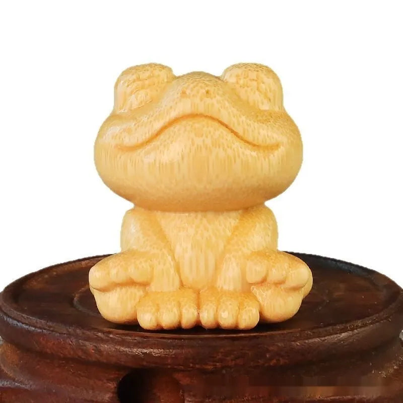 Solid bamboo smiling frog carving ornament measuring 5cm high with 120ml oil glove brush.