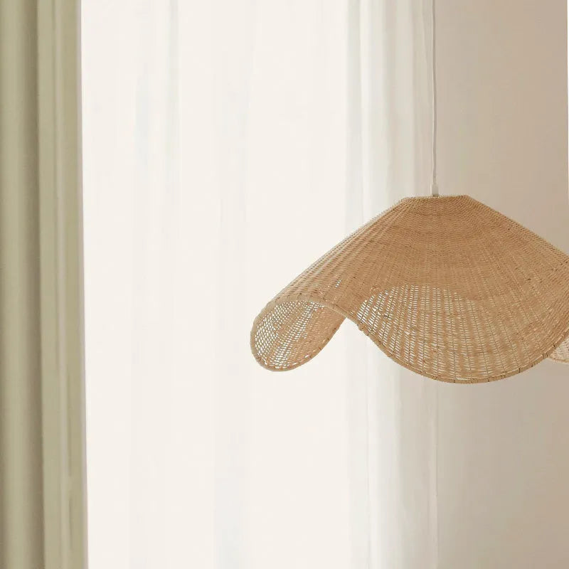 Handmade natural bamboo rattan pendant light chandelier with a woven lampshade emitting a warm glow.