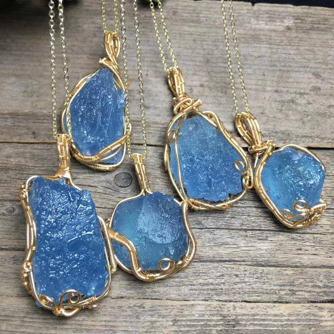 Natural raw aquamarine stone pendant hand-wrapped in gold copper wire with starry sky design