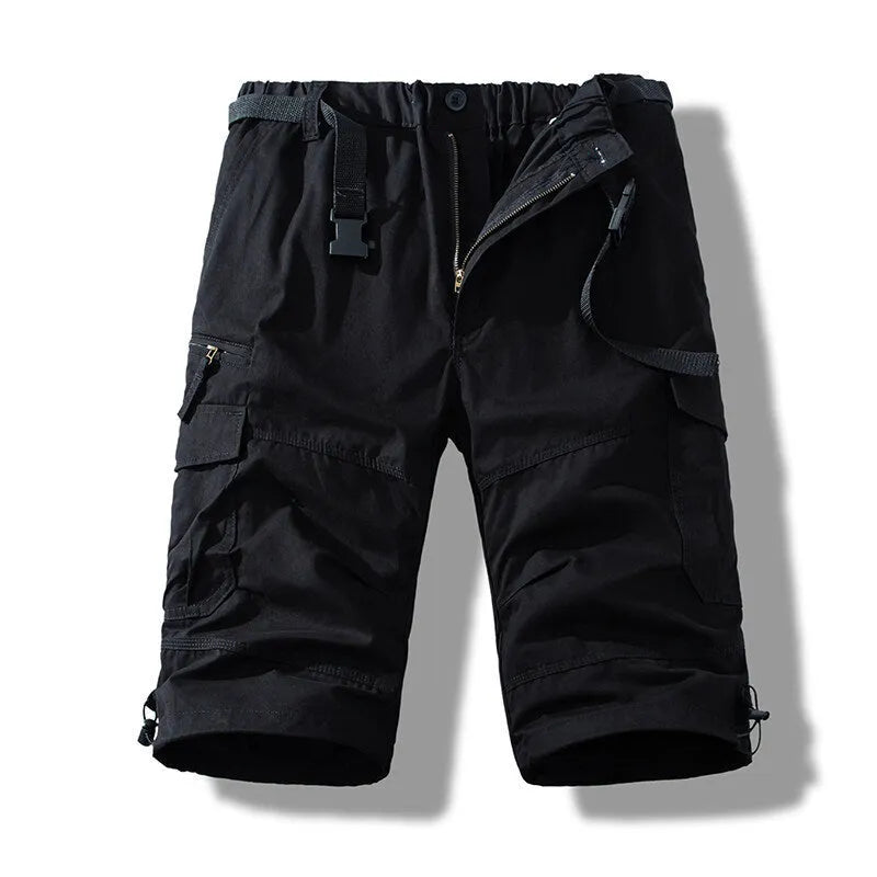 Man wearing thin cotton cropped overalls in army green, showing the relaxed summer fit.