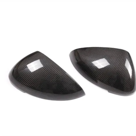 True carbon fibre exterior rearview mirror covers for a black Porsche Macan.