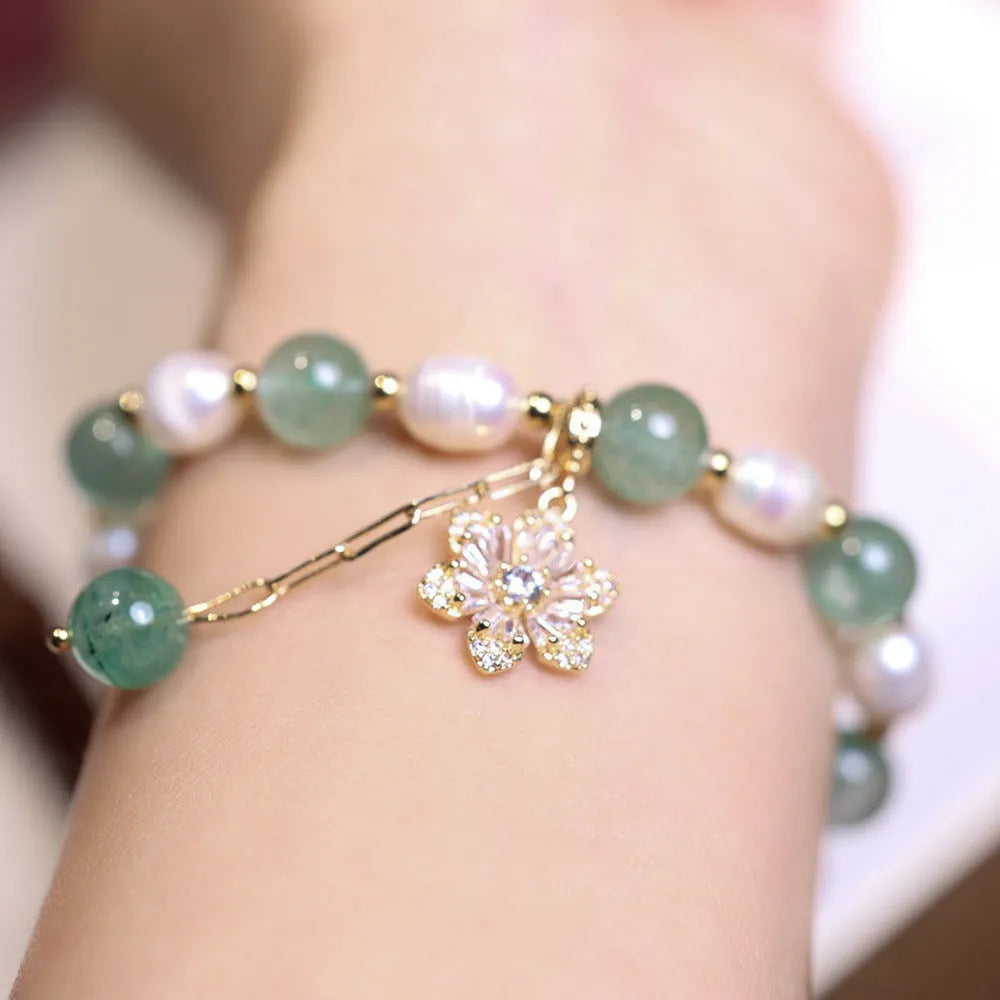 Green freshwater pearl bracelet with Chinese knot design and strawberry pearl hanging detail