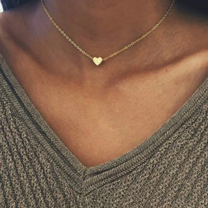 Elegant gold-tone double-sided love pendant necklace with clavicle chain, a versatile accessory for any outfit