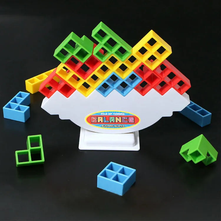Plastic balance stacking game with coloured building blocks, chassis, and base on a table