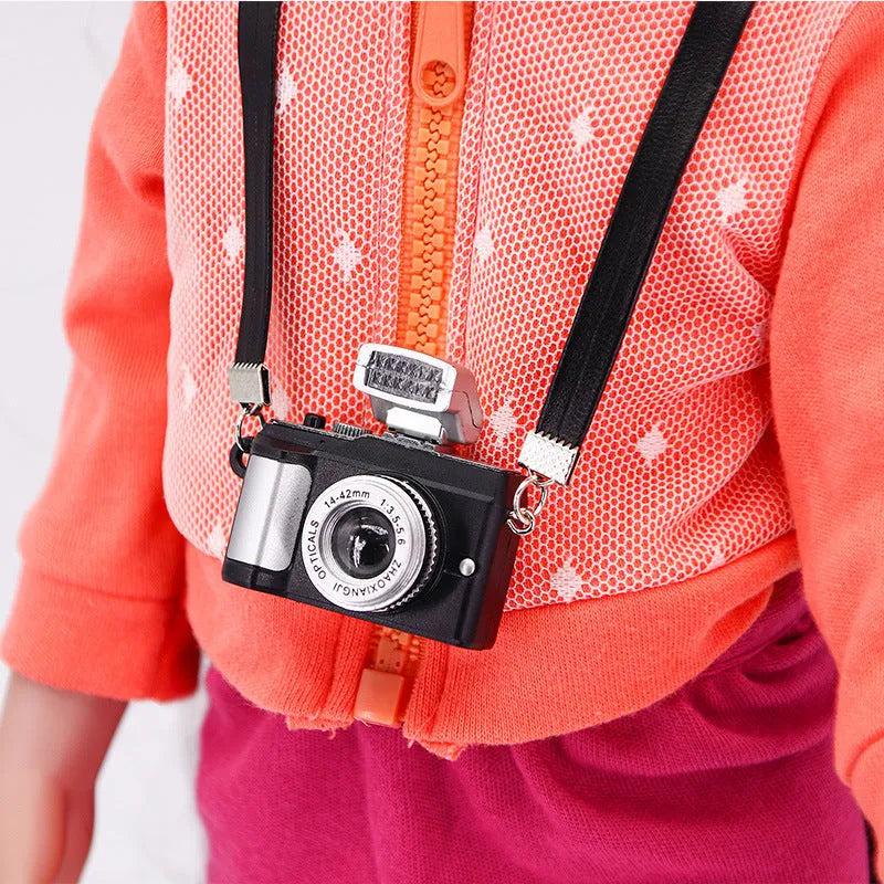 Plastic shrinking toy doll camera accessory with lanyard in digital style, packaged in net bag