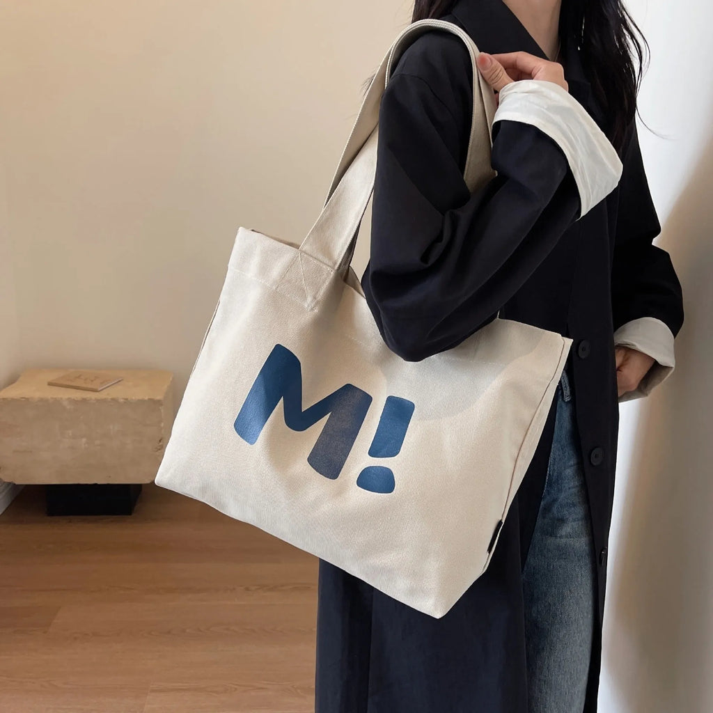 Letter print canvas shoulder bag in dark brown, large capacity tote with shoulder strap for women and girls.