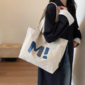 Letter print canvas shoulder bag in dark brown, large capacity tote with shoulder strap for women and girls.