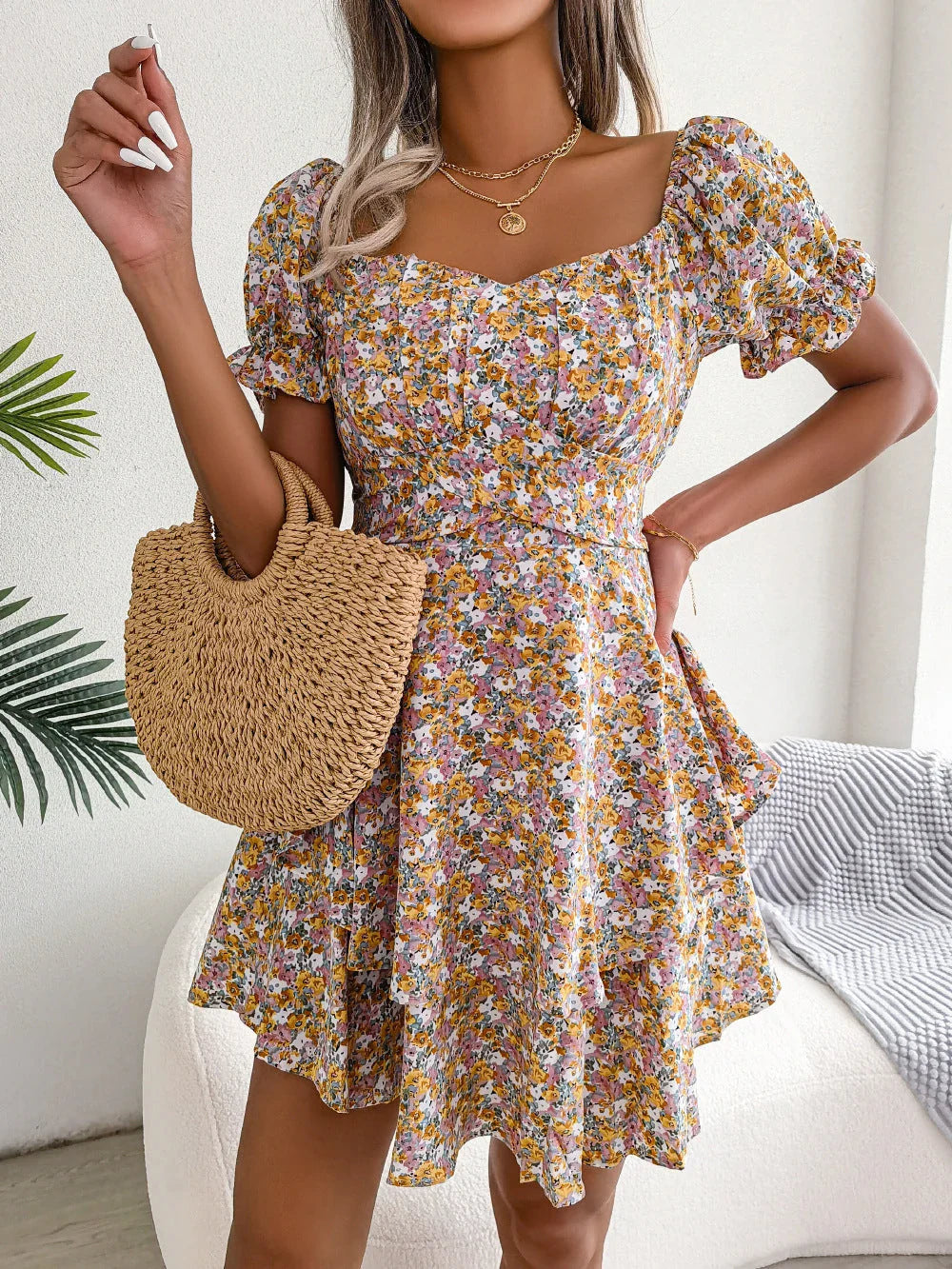 A stylish floral mini dress with a swing silhouette, featuring a high-waist design, short sleeves, and a vibrant floral print.