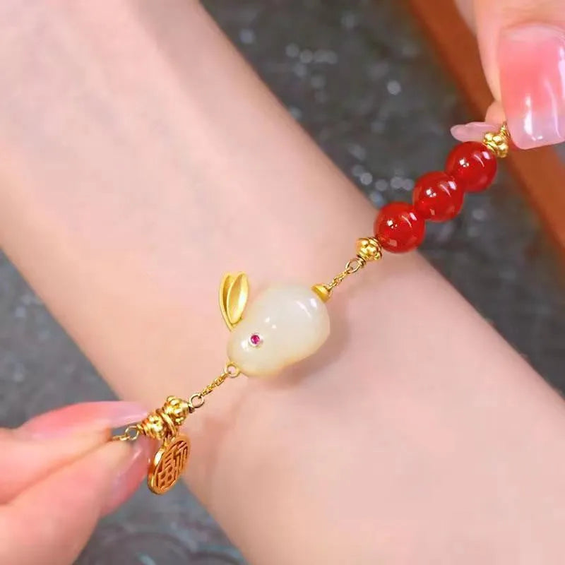 Green electroplated bracelet with a Chinese style hare charm and lily decoration for women.