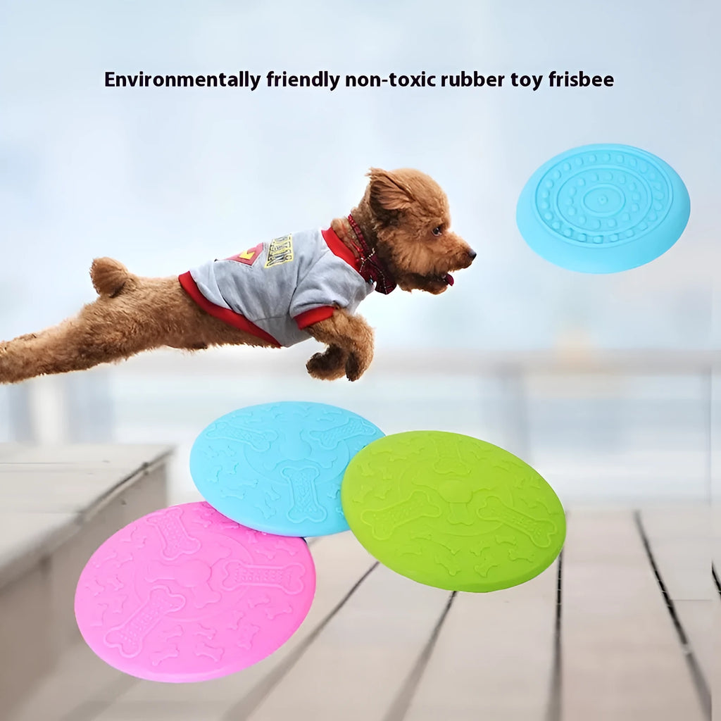 Plastic dog frisbee toy in green, shown on grass for fetch play.