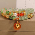 Peacock green agate double ring bracelet for women with safety buckle clasp and rhinestone details.