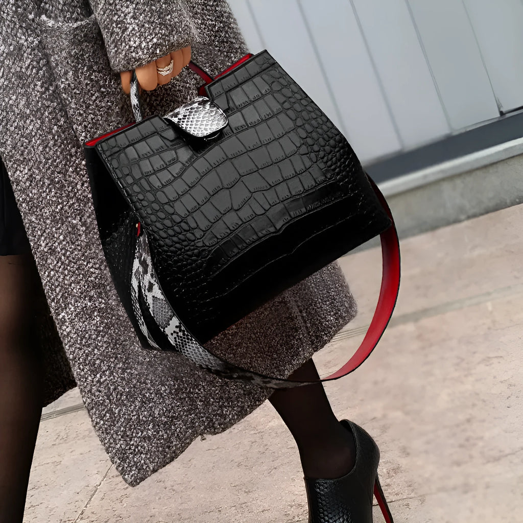 Black women's messenger bag bucket shape with colour contrast detailing and zipper closure