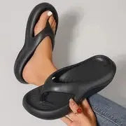 Women's thick-soled flip flops with non-slip textured soles in black, white, and grey colour options