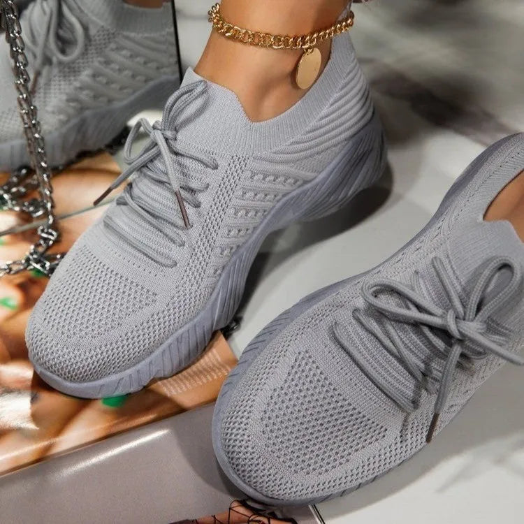 Women's solid colour sneakers with a thick sole, shown in one of nine available colours.