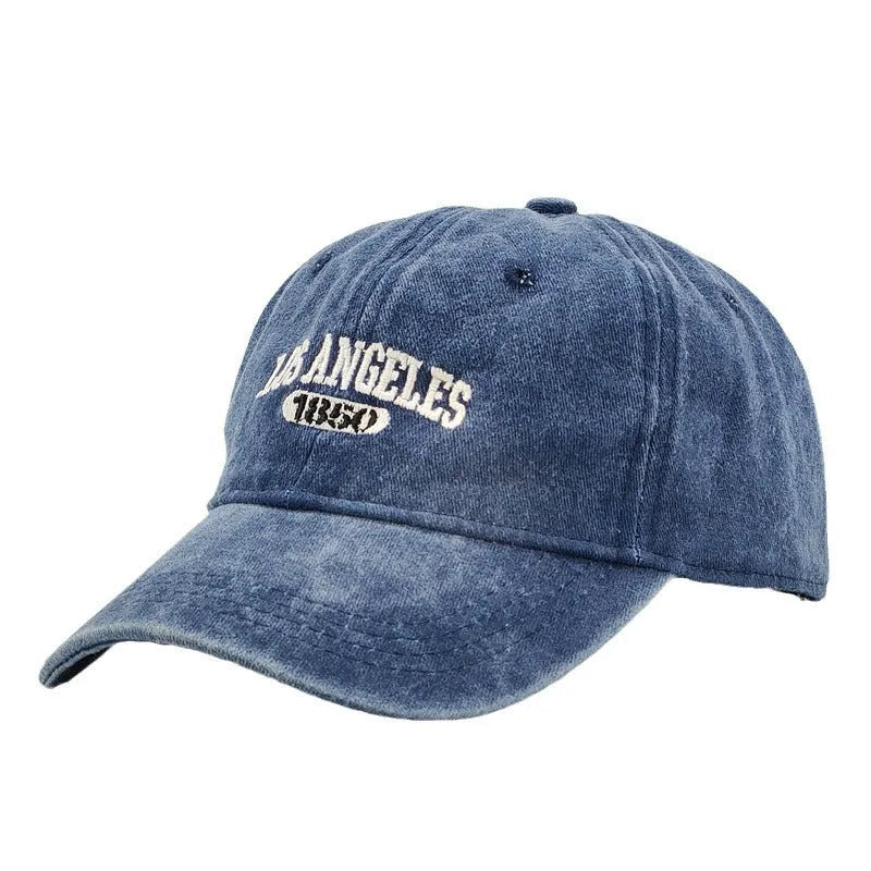 Retro distressed acrylic cap with embroidered letters, shown in beige colour with adjustable strap.
