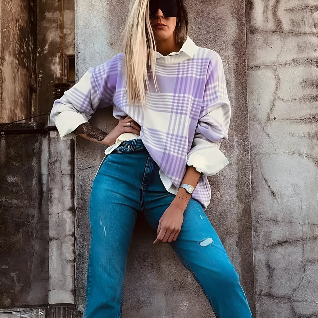 Lilac plaid print loose sweater with ribbed cuffs and hem on a hanger.